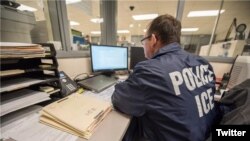 Un oficial de ICE monitorea una operación de la agencia. 